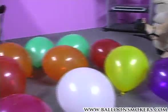 Teen blows to pop pink balloons